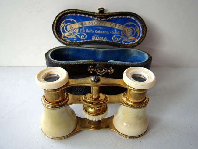 A pair of Italian ivory opera glasses with their original satin lined black leather case made by A. Ramoni, Opticians, of Rome circa 1900.